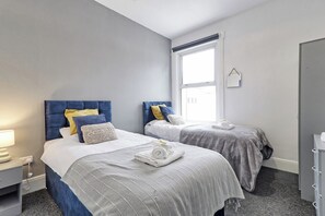 Enjoy a restful sleep in this bedroom with plush double beds.