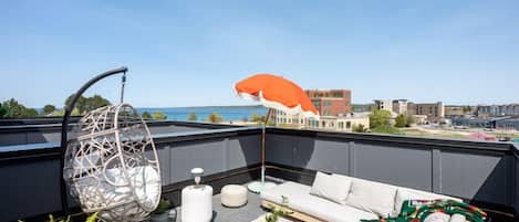 Enjoy a private rooftop lounge with a unique hanging chair, offering a secluded and cozy spot to unwind and take in the views.