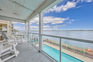 Large balcony overlooks the bay and the pool