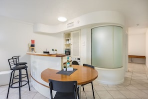 Kitchen includes a built-in dining table.