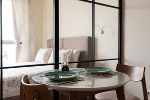 Dining table for two, beautiful dishes and comfortable chairs.