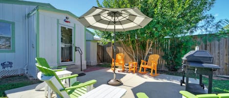 Rock the Boat features a beautiful backyard with a patio, lawn, outdoor seating, and grill.