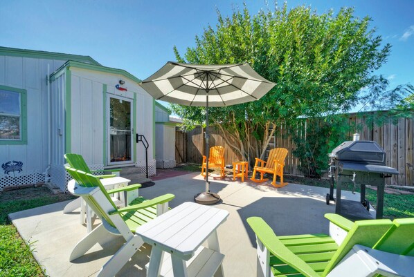 Rock the Boat features a beautiful backyard with a patio, lawn, outdoor seating, and grill.