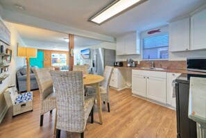 Dining table near the kitchen has seating for four.