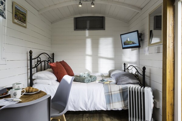 Relax in the comfort of the 5' king-size bed surrounded by crisp, white walls