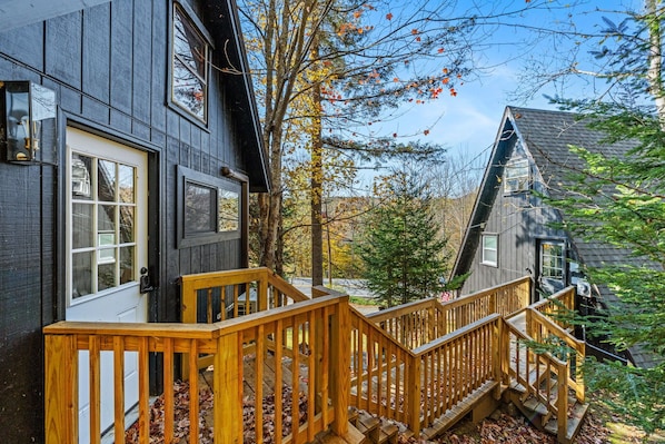 View of the outside with the bunk house on the left and the main A-frame house on the right.