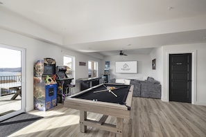 Basement Level: Pool Table, Arcades, and Shuffle Board in Game Room 