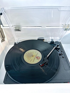 The vintage turntable in the livi8ng room is a fun way to spend time playing your favorite 70's records!