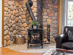 Beautiful stone backdrop with a warm cozy wood burning stove