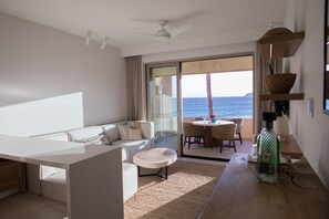 Desk and living room opening to balcony