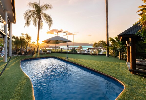 Watch the sunset from the private pool over Coral Sea Marina