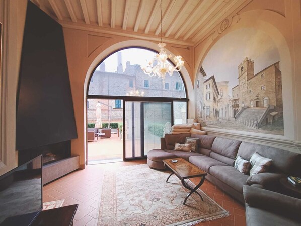 Living room with fireplace and door to outdoor terrace