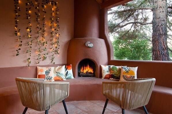 Outdoor patio with wood-burning kiva fireplace