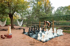 Giant Chess, Yard Yahtzee, Jumbo Jenga, and comfortable hammock chairs for the spectators