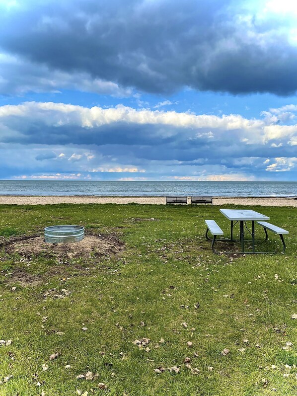 Backyard has direct access to the Bay, fire pit, picnic table and benches