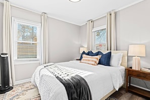 Experience the comfort of a queen-size bed in this room, enhanced by the presence of two generously sized windows. Bask in the natural light that fills the space, creating a bright and welcoming atmosphere.