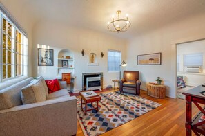 View from front door of living room with sleeper sofa and bedroom