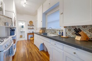View of well-appointed kitchen that leads into the bathroom