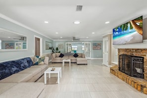 Living room with plenty of seating for the family and large UHD Smart TV