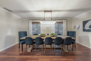 he expansive table provides ample room for everyone, ensuring a comfortable dining experience.