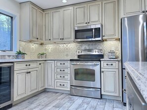 Step into elegance and sophistication in our kitchen, adorned with sleek white and black accents.