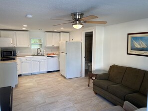 View of living room and kitchen space from entry door