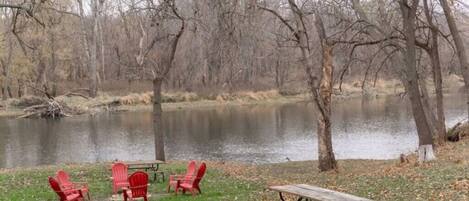 Enjoy the river with a firepit & two picnic tables for outdoor activities.