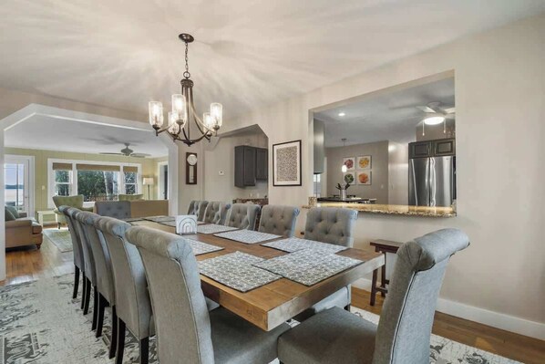 Dining area  sits 12. Open concept to kitchen and living area with fireplace.