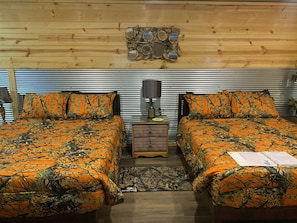 two comfy queen beds in the Buffalo Wallow Cabin at The Lazy Buffalo, Cache