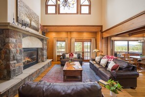 Stonework fireplace and elevated windows make for a stunning design