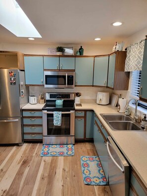 Kitchen has many appliances including an air fryer