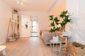 Restful sleeping area with a comfy double bed, soft bedding and a touch of greenery — perfect for a peaceful night’s sleep.