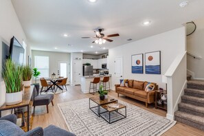 A bright and inviting living room with a comfy sofa, smart TV, and stylish decor—perfect for unwinding or entertaining guests.