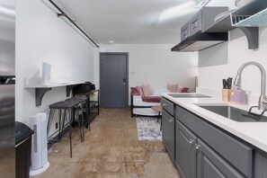 Delight in the harmony of form and function in our open kitchen, a chic and thoughtfully designed culinary sanctuary exuding both practicality and aesthetic allure.