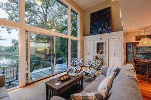 The picture window overlooking the river is one of this home's best features. Great Blue Herons sun themselves on the dock!