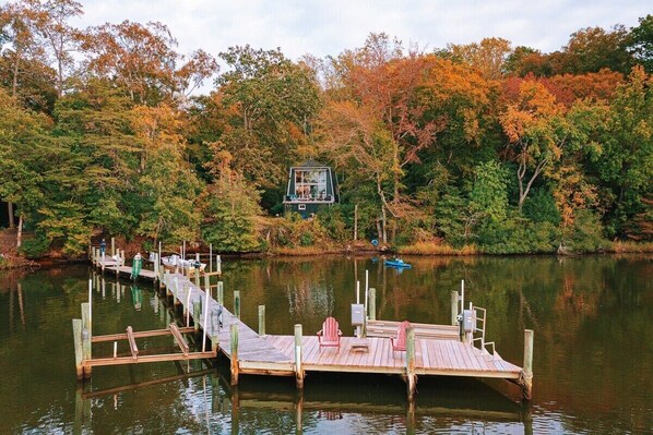 A view of the dock and house in background from a kayak. Beautiful fall colors!