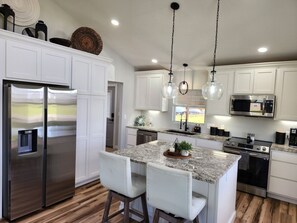 Kitchen with granite counter tops is completely equipped with all the essentials for cooking