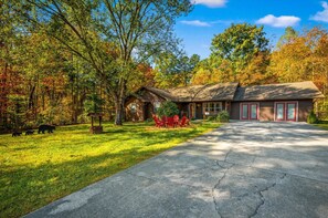 PineCove features an expansive front yard with firepit, large driveway, and exceptional mountain views