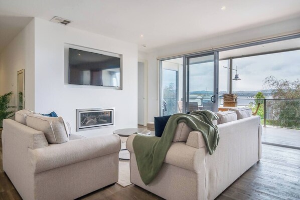 The living room opens to the covered balcony, creating a beautiful transition between the indoors and out.
