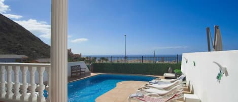 Lovely sunny pool area with sea views in the distance