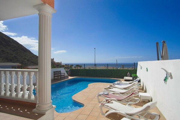 Lovely sunny pool area with sea views in the distance