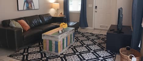 Living room, confertable leather sectional for movie night.