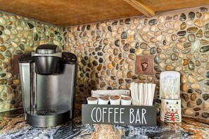 Keurig coffee maker with coffee, cream and sugar.