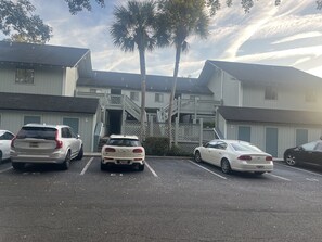 One assigned parking spot, with an open lot on the other side.