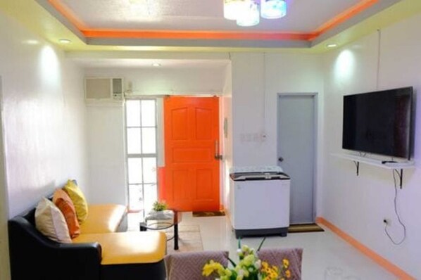 Chill in our living area with our smart TV with a sound system, centralized AC, and free Wifi. This is also where the first bathroom is located, with a washing machine.