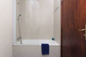 The bathroom is equipped with towels, shampoo and hair dryer.