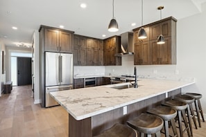 Luxury Kitchen with Stainless Steel Appliances & Bar Seating