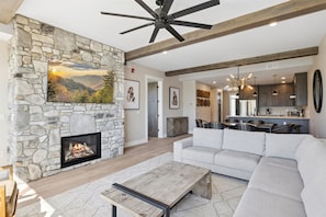 Spacious Living Room - Spacious and Scenic Living Room with Stone Fireplace, Floor to Ceiling Windows with Smoky Mountain View, Smart TV's and WiFi throughout vacation condo
