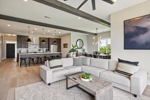 Spacious and Scenic Living Room with Stone Fireplace, Floor to Ceiling Windows with Smoky Mountain View, Smart TV's and WiFi throughout vacation condo