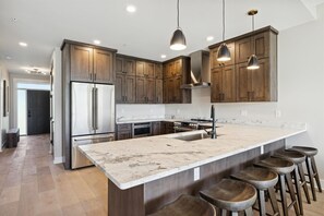 Luxury Kitchen with Stainless Steel Appliances & Bar Seating